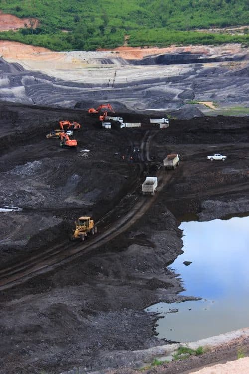 Excavators and dump trucks at an open-pit mine