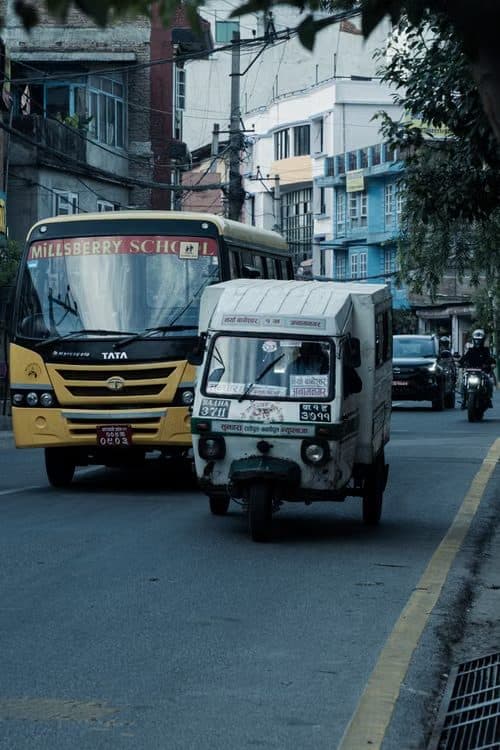 A school bus and a delivery vehicle on a city street