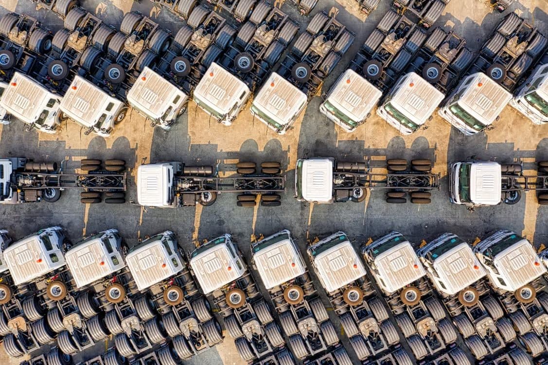 Rows of trucks parked in a fleet yard, seen from above
